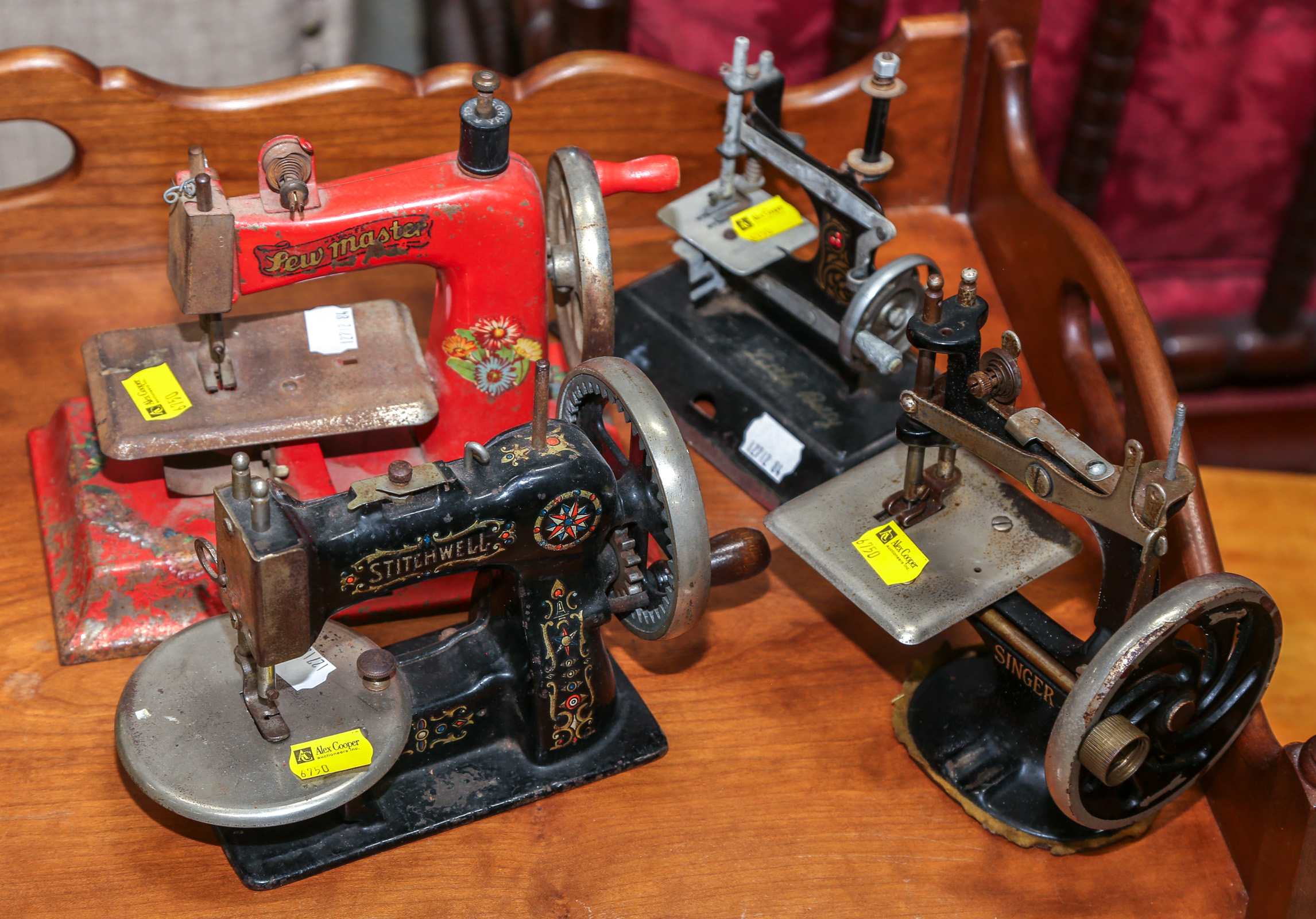 FOUR ANTIQUE TOY SEWING MACHINES