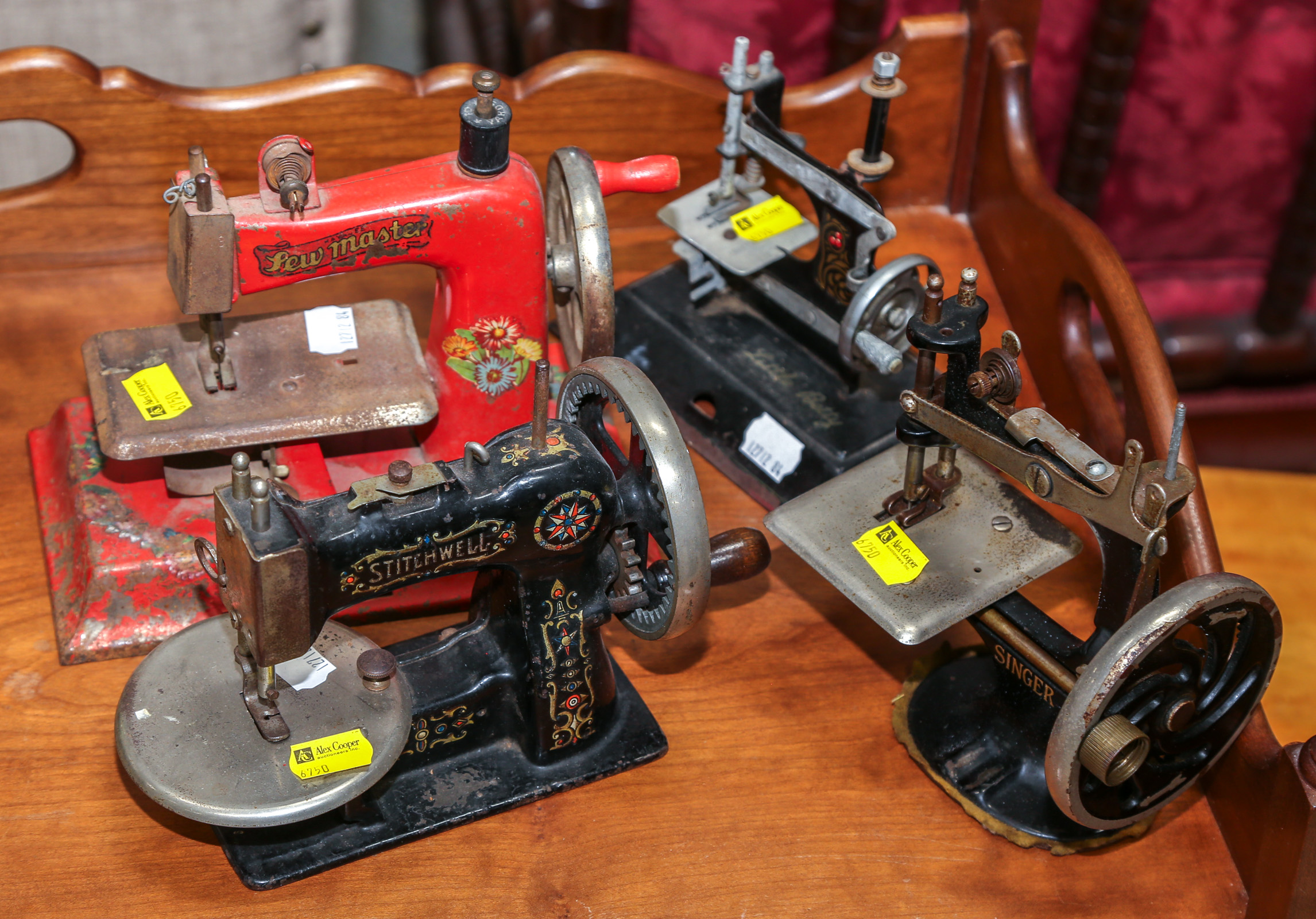 FOUR ANTIQUE TOY SEWING MACHINES 3c78fb