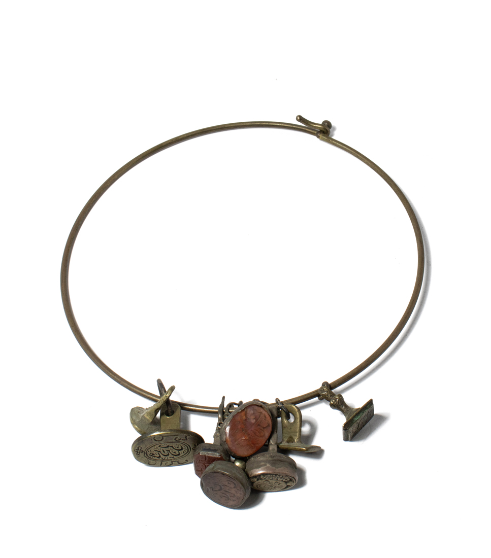 A BRASS CHOKER FITTED WITH EIGHT