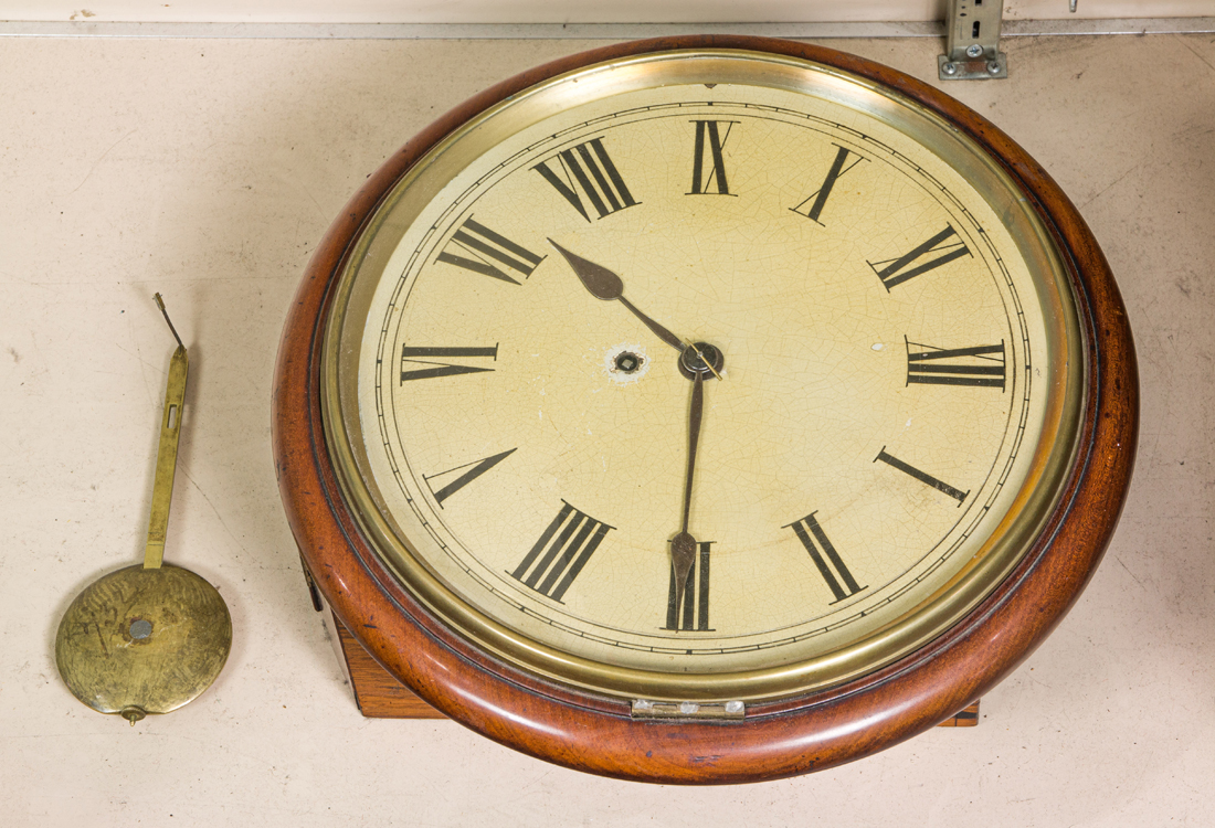 A MAHOGANY ROUND WALL CLOCK A mahogany