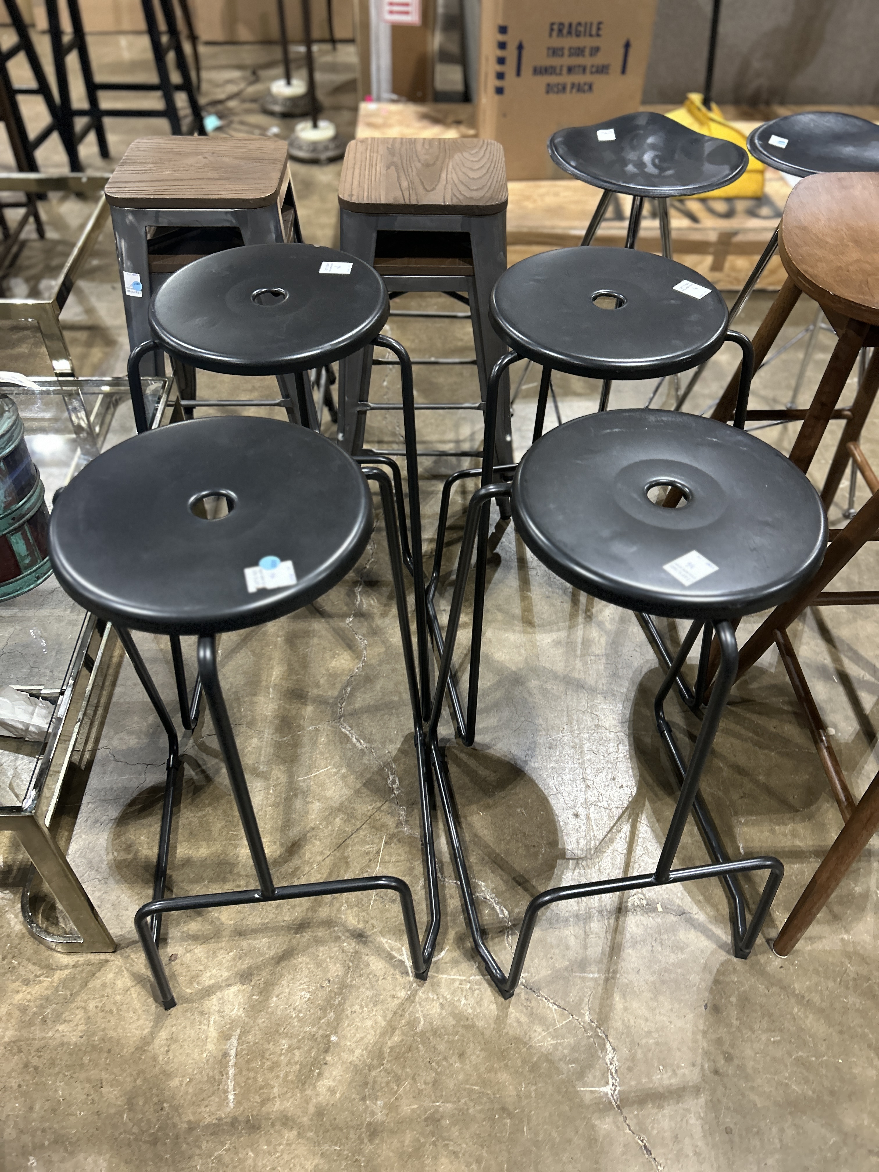 FOUR BENT METAL STACKING BAR STOOLS