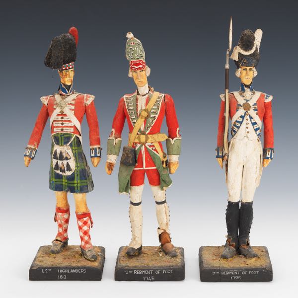 THREE CARVED WOOD SOLDIER FIGURINES