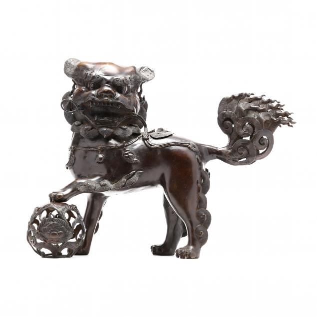 A CHINESE BRONZE FOO LION STANDING