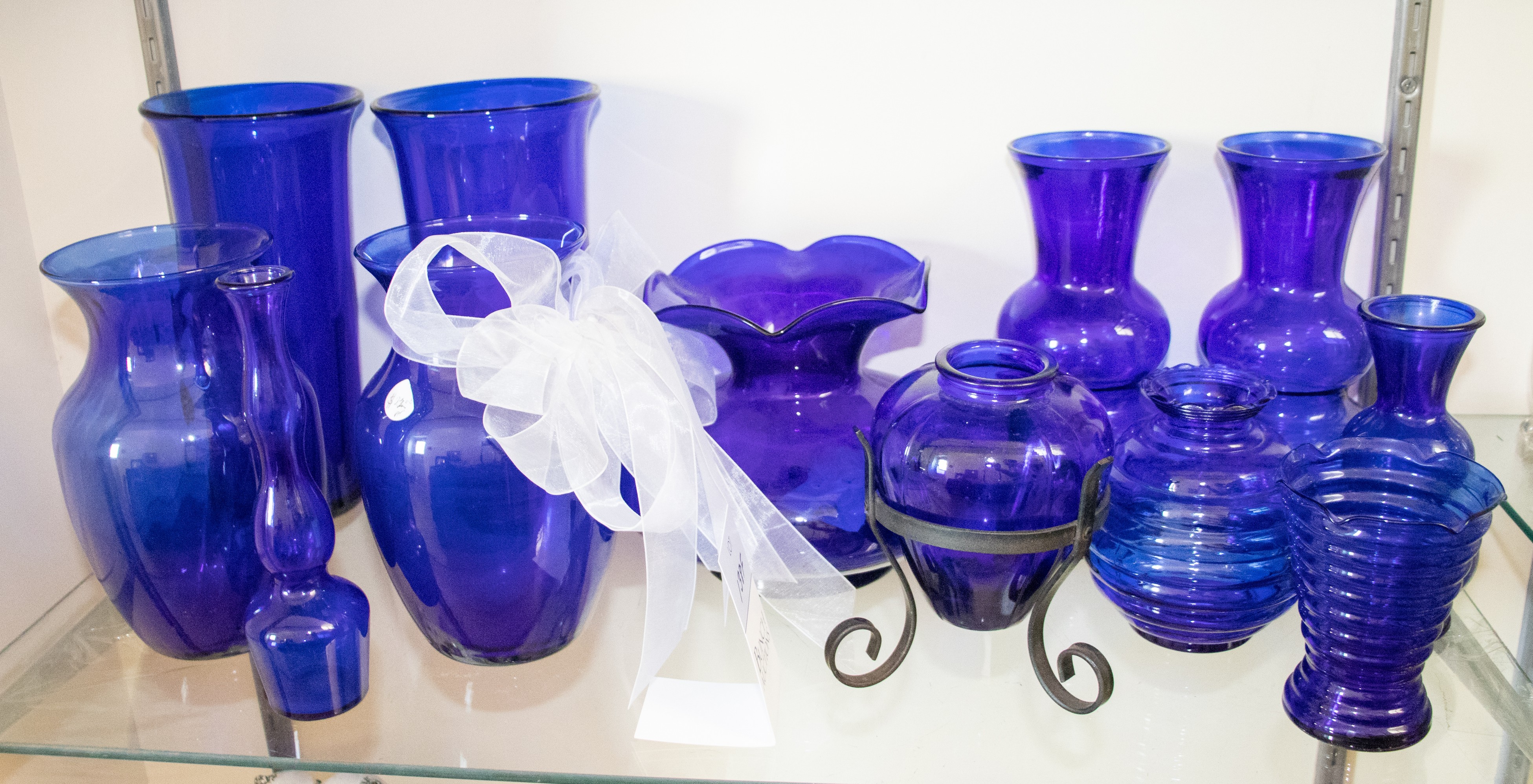 (12) Blue glass vases, tallest 10"
