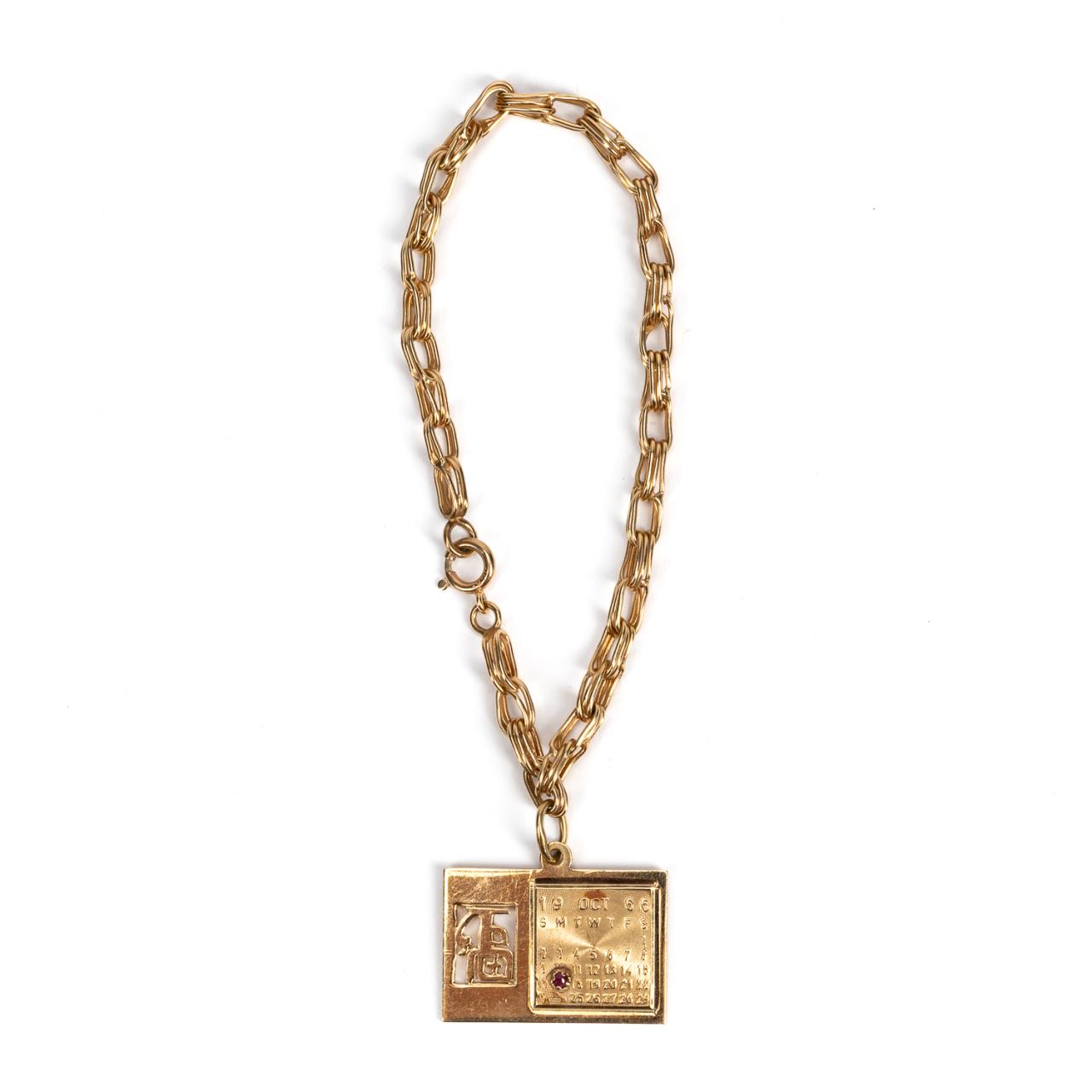 14K GOLD CALENDAR CHARM WITH RUBY &