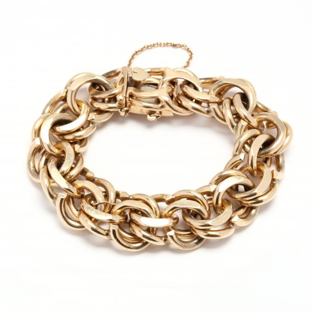 14KT GOLD BRACELET The heavy curb