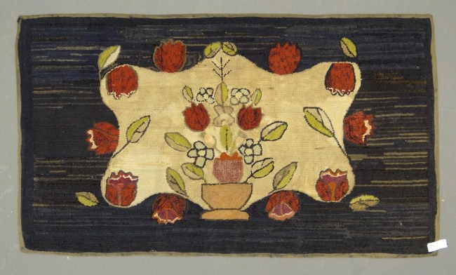 19th c. urn with flower hooked rug.