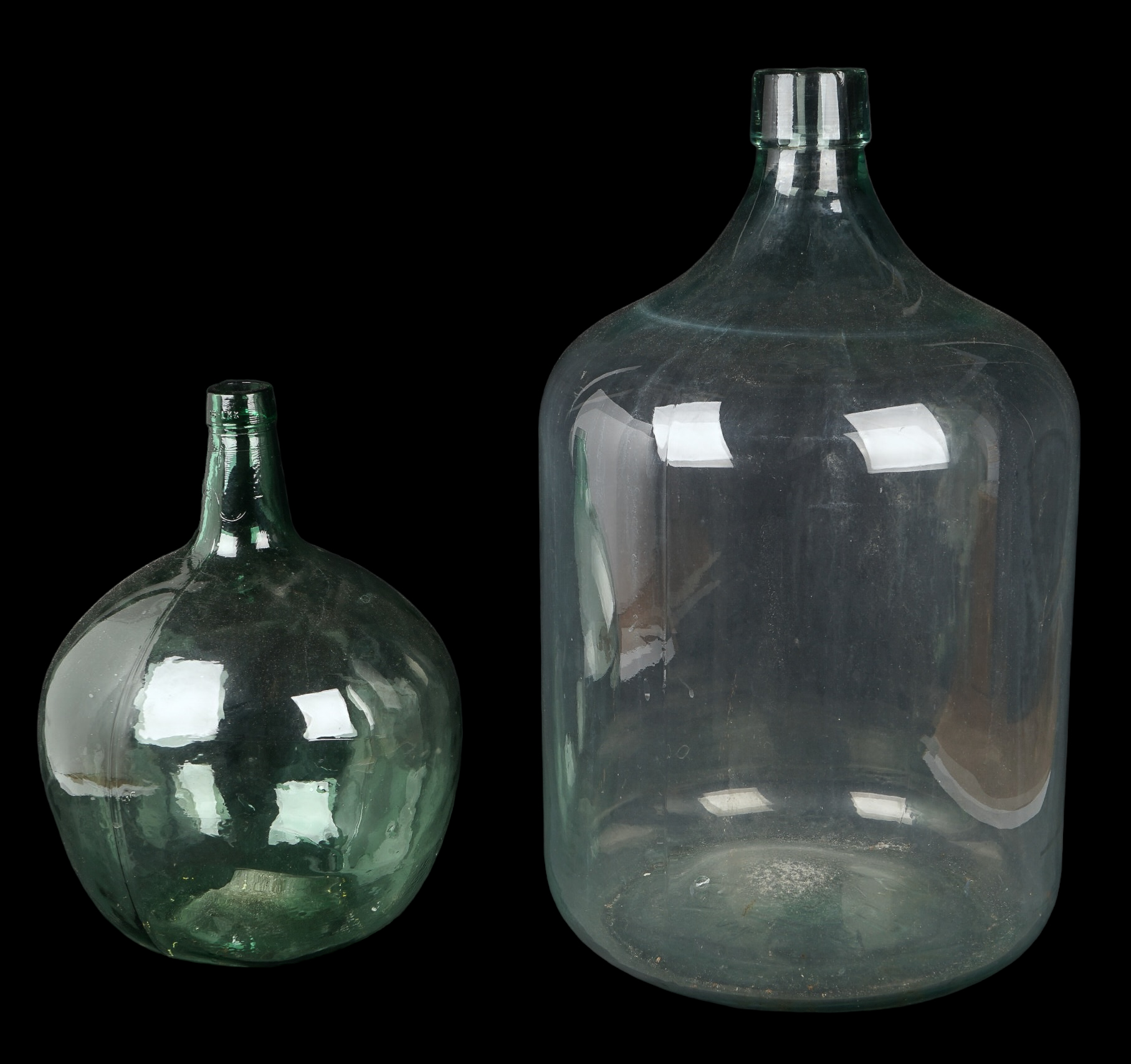 (2) Aqua green glass demijohns, c/o