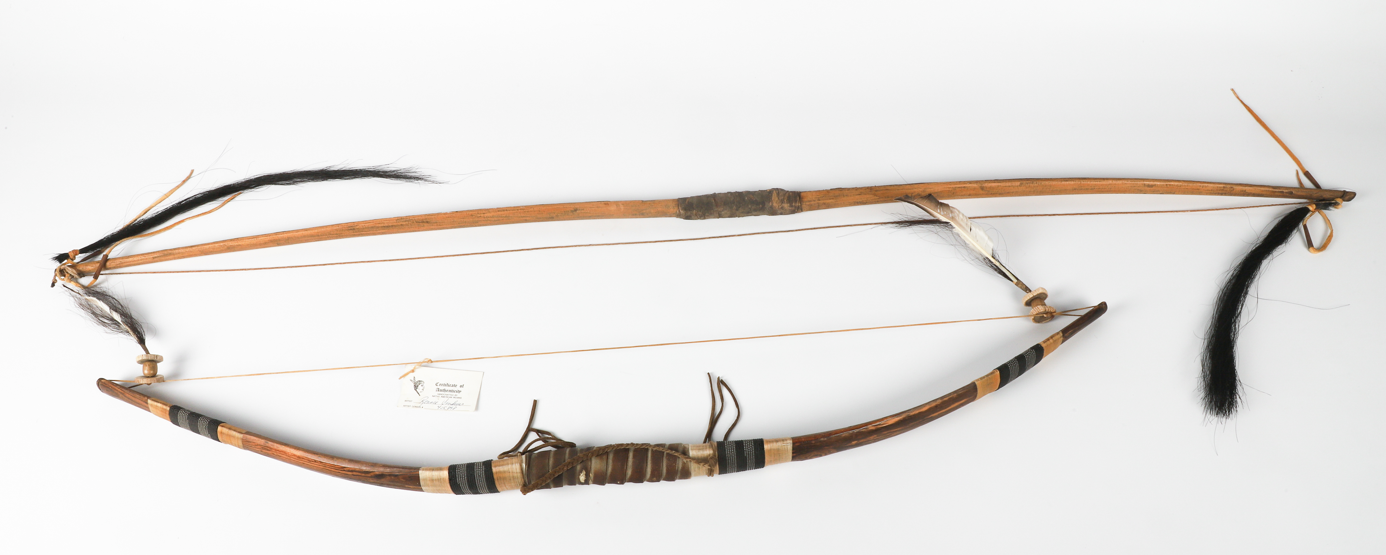 (2) Native American wood and hyde