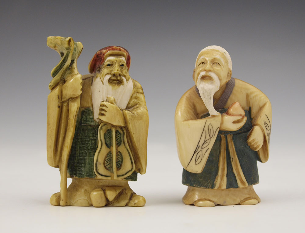 2 PIECE CARVED IVORY TINTED FIGURES