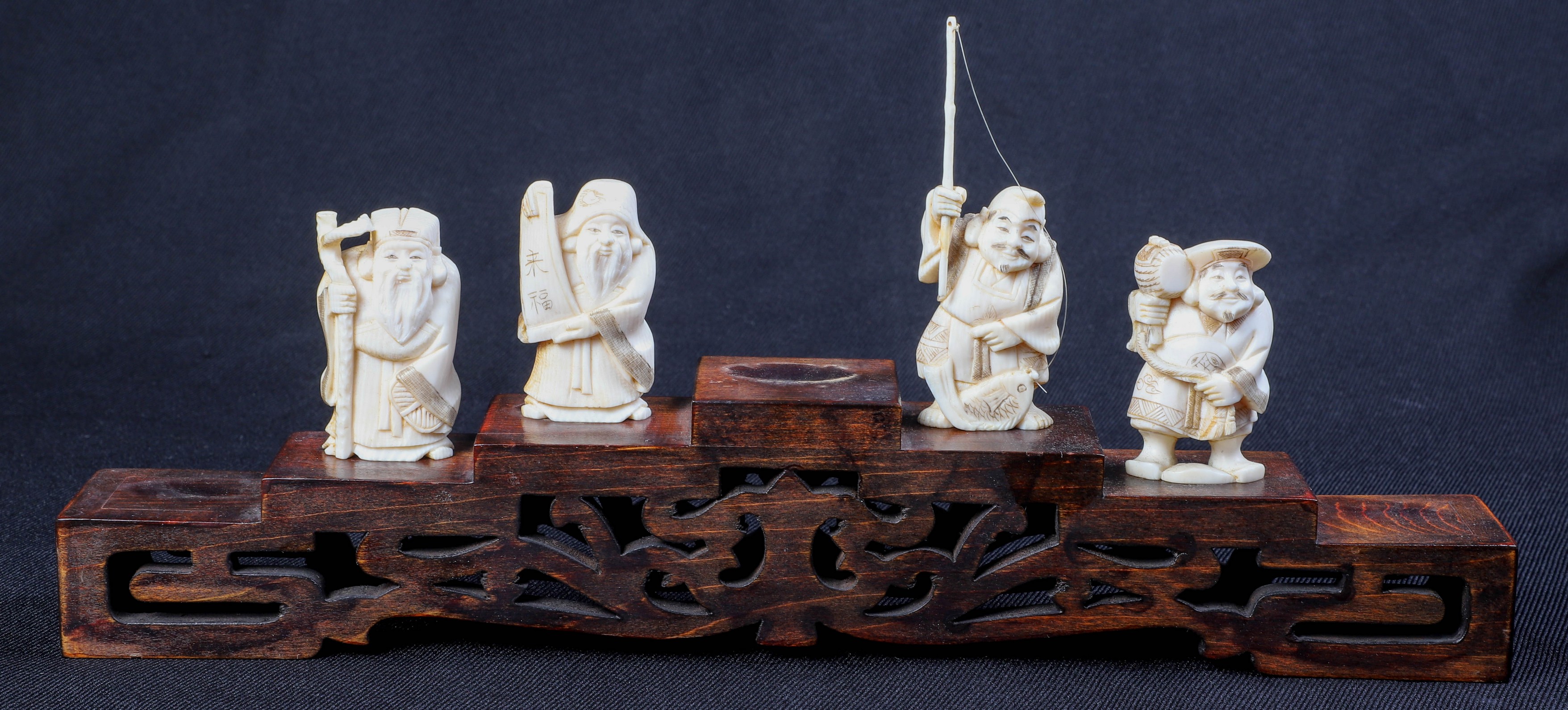 (4) Carved ivory figures,
