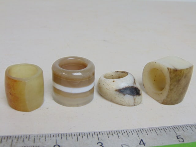 4 CHINESE ARCHER RINGS, CARVED