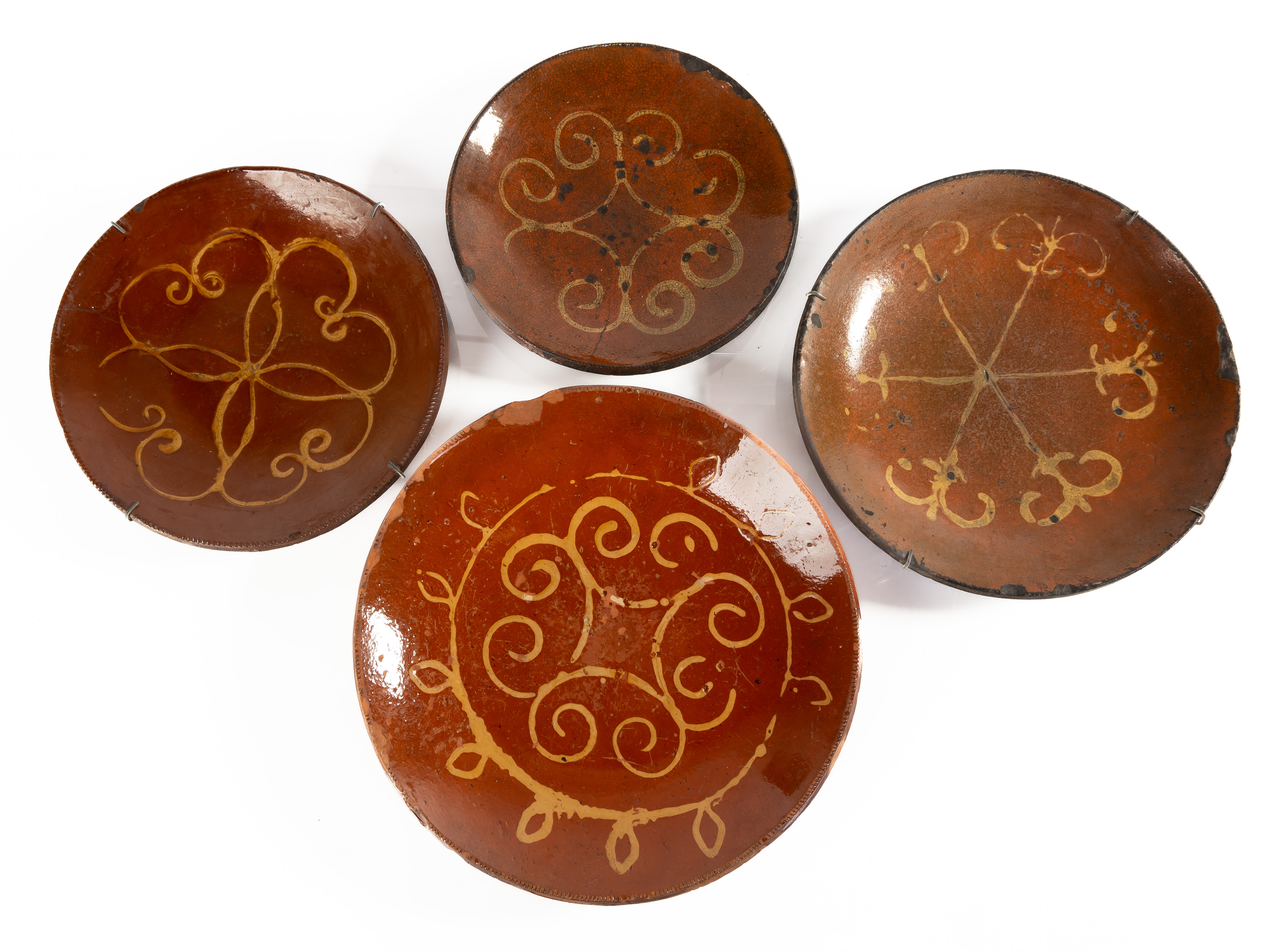 (4) DECORATED REDWARE PLATES