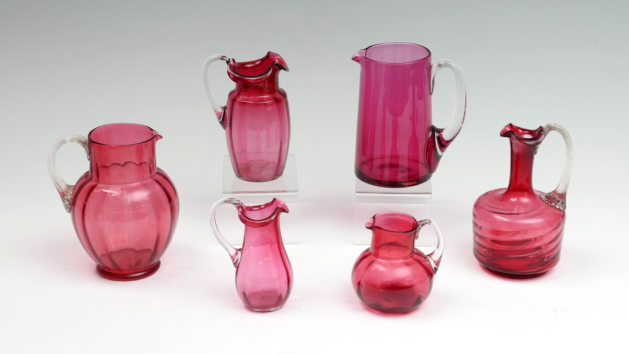 6 PC. CRANBERRY ART GLASS PITCHERS: