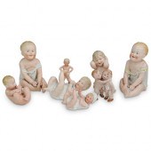 (8PC) PORCELAIN BABY FIGURINE