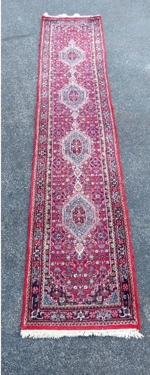 A 14FT PERSIAN BIDJAR RUNNER IN