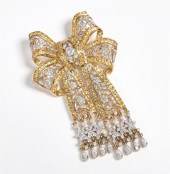 A 18K YELLOW GOLD BOW BROOCHA