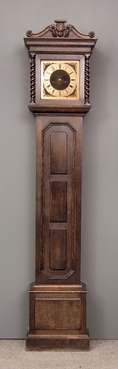 A 1920s dark oak longcase clock