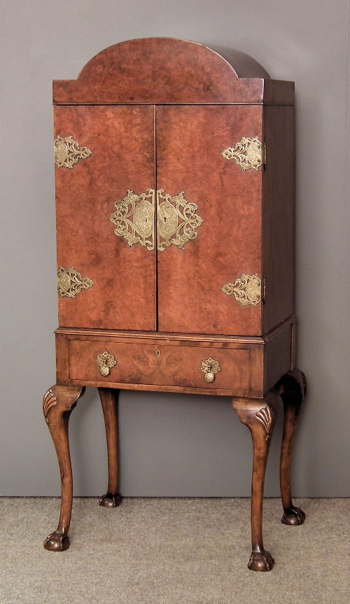 A 1930s figured walnut and brass