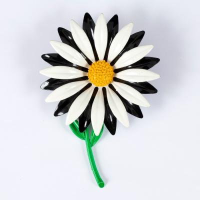 A 1960s style enamelled brooch in