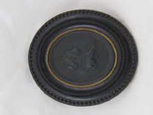 A 19th c. black basalt cameo of a