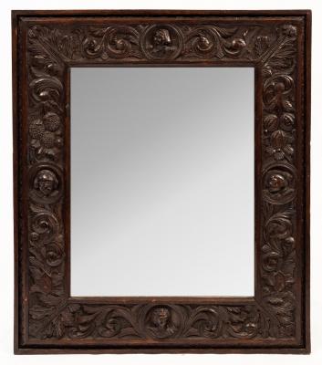 A 19th Century carved oak mirror,