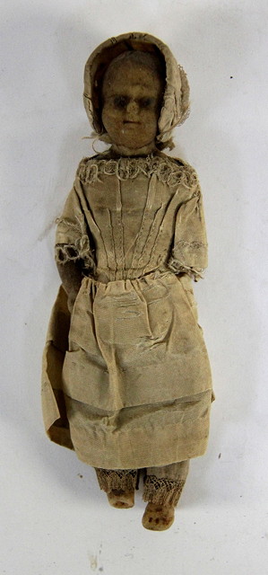 A 19th century wax head doll in a