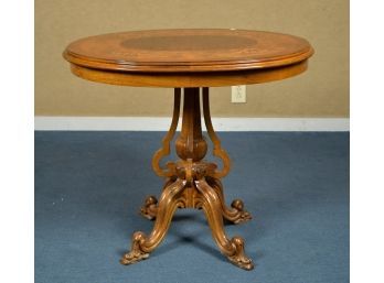 A 20th C. center table with an oval