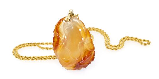 A 24 Karat Yellow Gold and Carved