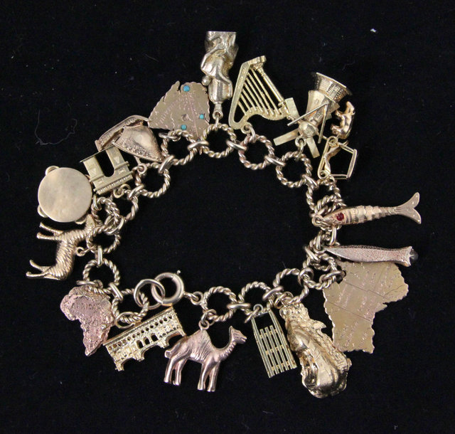 A 9ct gold charm bracelet hung with