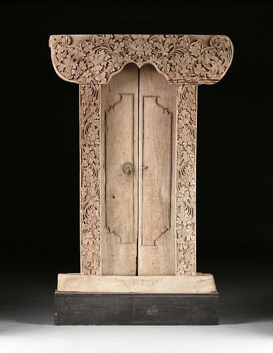 A BALINESE PADMA CARVED TEAK