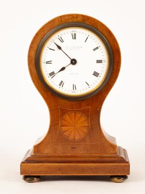 A balloon-shaped mahogany mantel