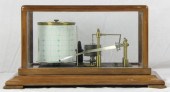 A barograph in a glazed mahoga
