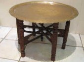 A Benares brass table with pie
