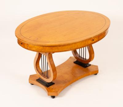 A Biedermeier oval table, fitted