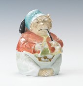 A Bisque Figural Smoking Monke