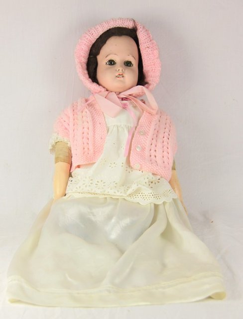 A bisque head doll with brown
