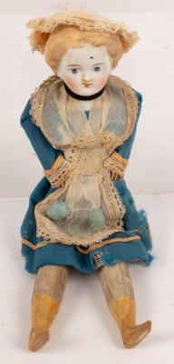 A bisque head doll with wooden legs