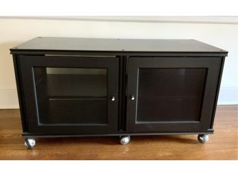 A black TV console with two metal