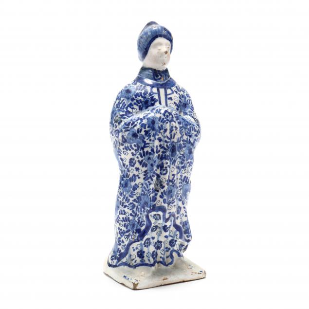 A BLUE AND WHITE DELFT FIGURE OF