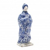 A BLUE AND WHITE DELFT FIGURE