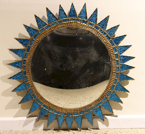 A BLUE SUNBURST MIRROR MANNER OF
