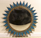A BLUE SUNBURST MIRROR MANNER