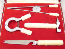 A boxed ivory handled cocktail