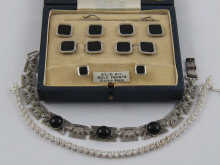 A boxed set of collar studs