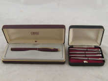 A boxed set of four white metal