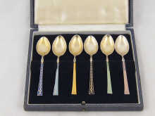 A boxed set of silver and enamel