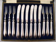 A boxed set of six white metal