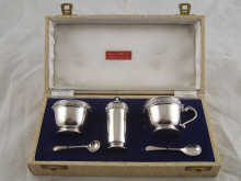 A boxed silver cruet set with