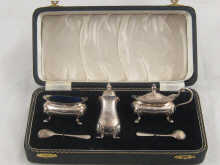 A boxed silver three piece cruet